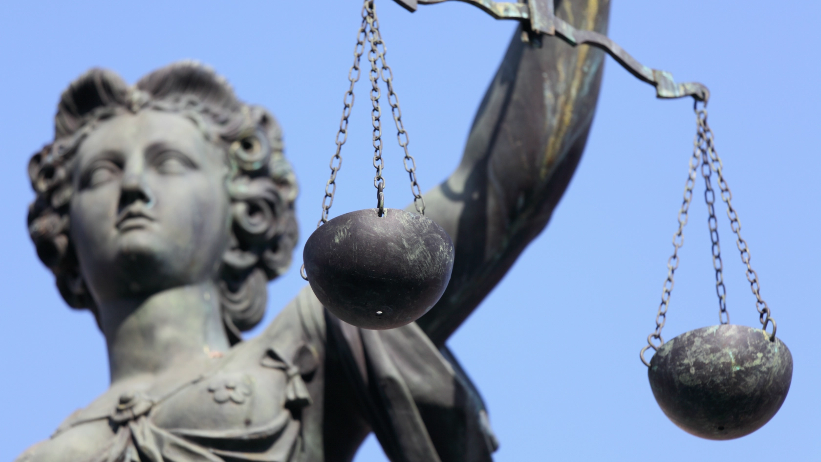 Eine Statue von Justizia mit Waage in der Hand