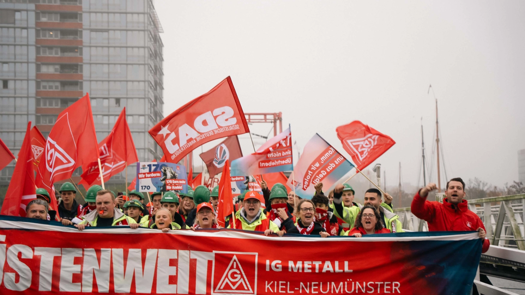 Allein in Kiel und Neumünster beteiligten sich am Dienstag 2.500 Beschäftigte aus 20 Betrieben an Warnstreiks. In zwei Demonstrationszügen zogen sie zu der zentralen Kundgebung vor der dritten Verhandlung in Kiel.