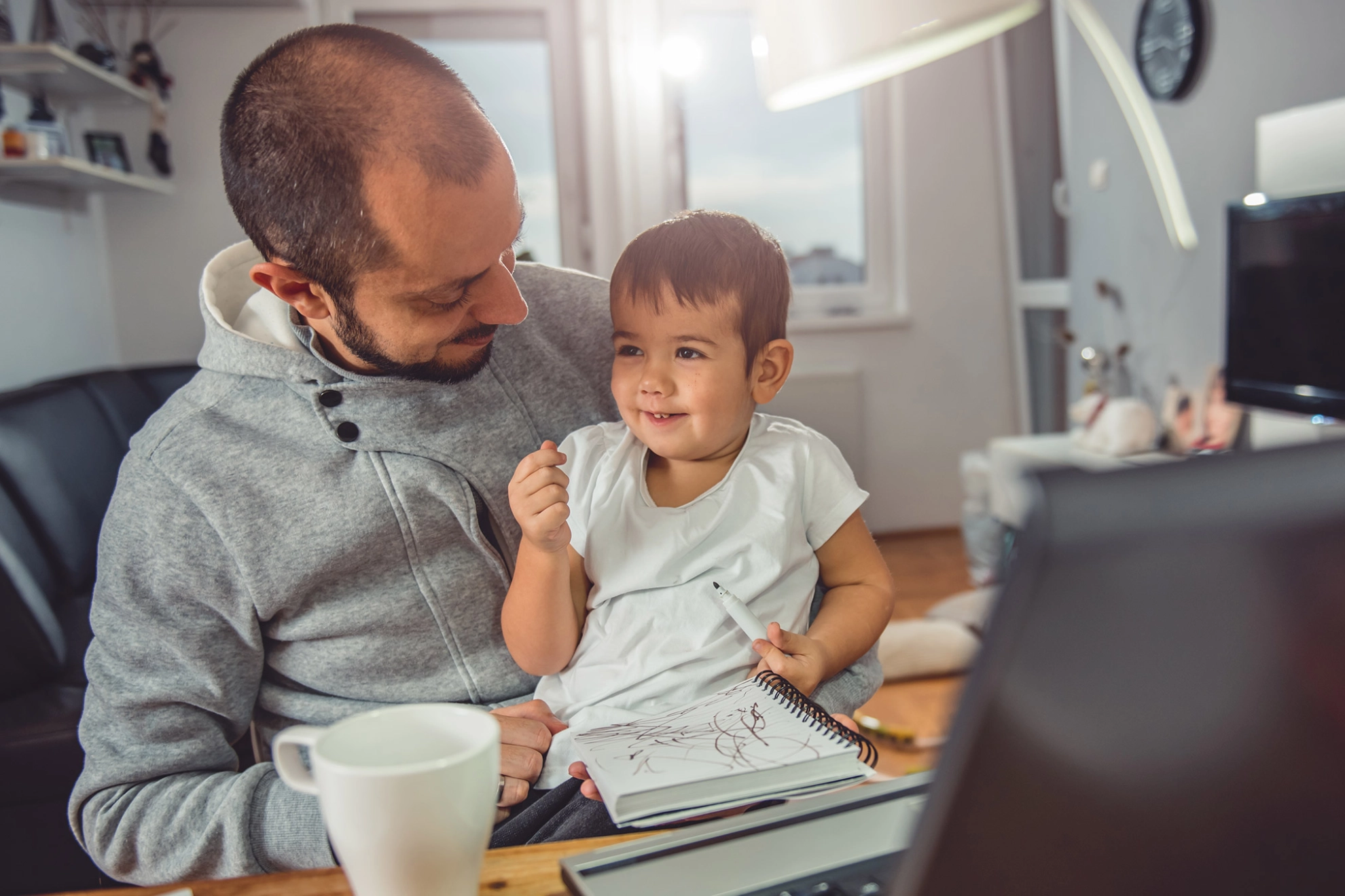 Vater spielt mit seinem Sohn vor dem Computer